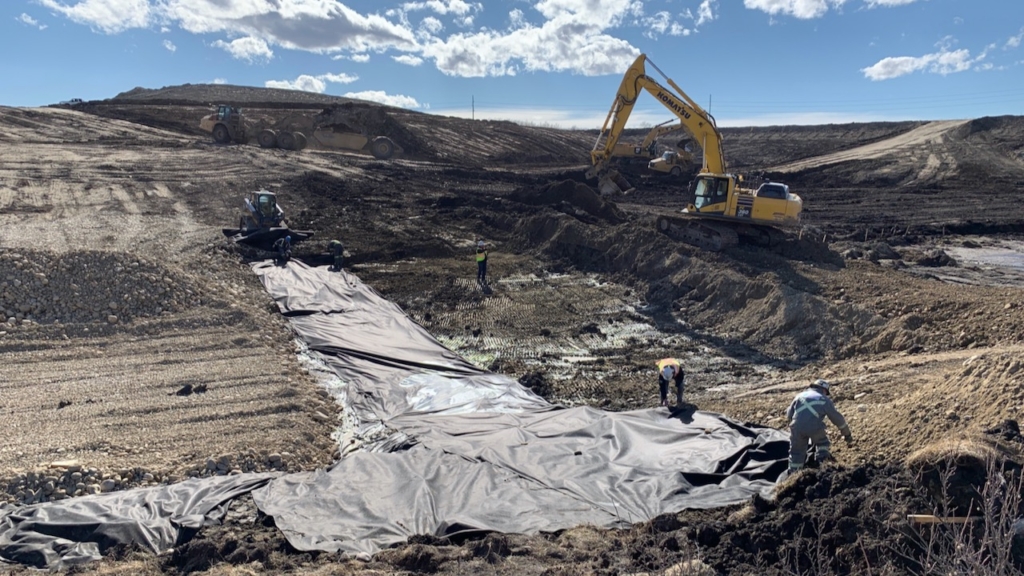 Placing geotextile fabric for the drainage culvert