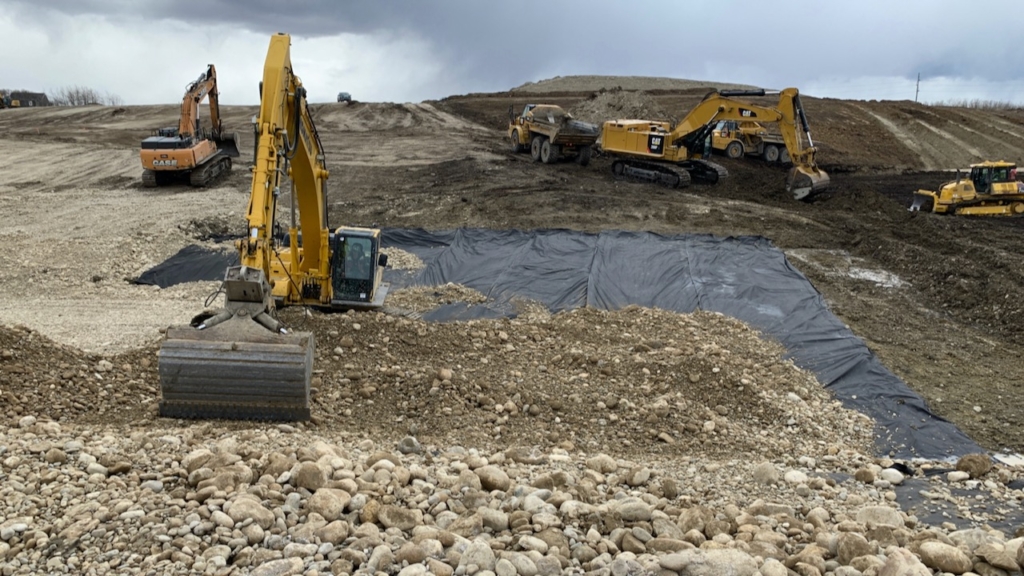 The geotextile fabric is covered with gravel that will provide the foundation for the culvert pipe